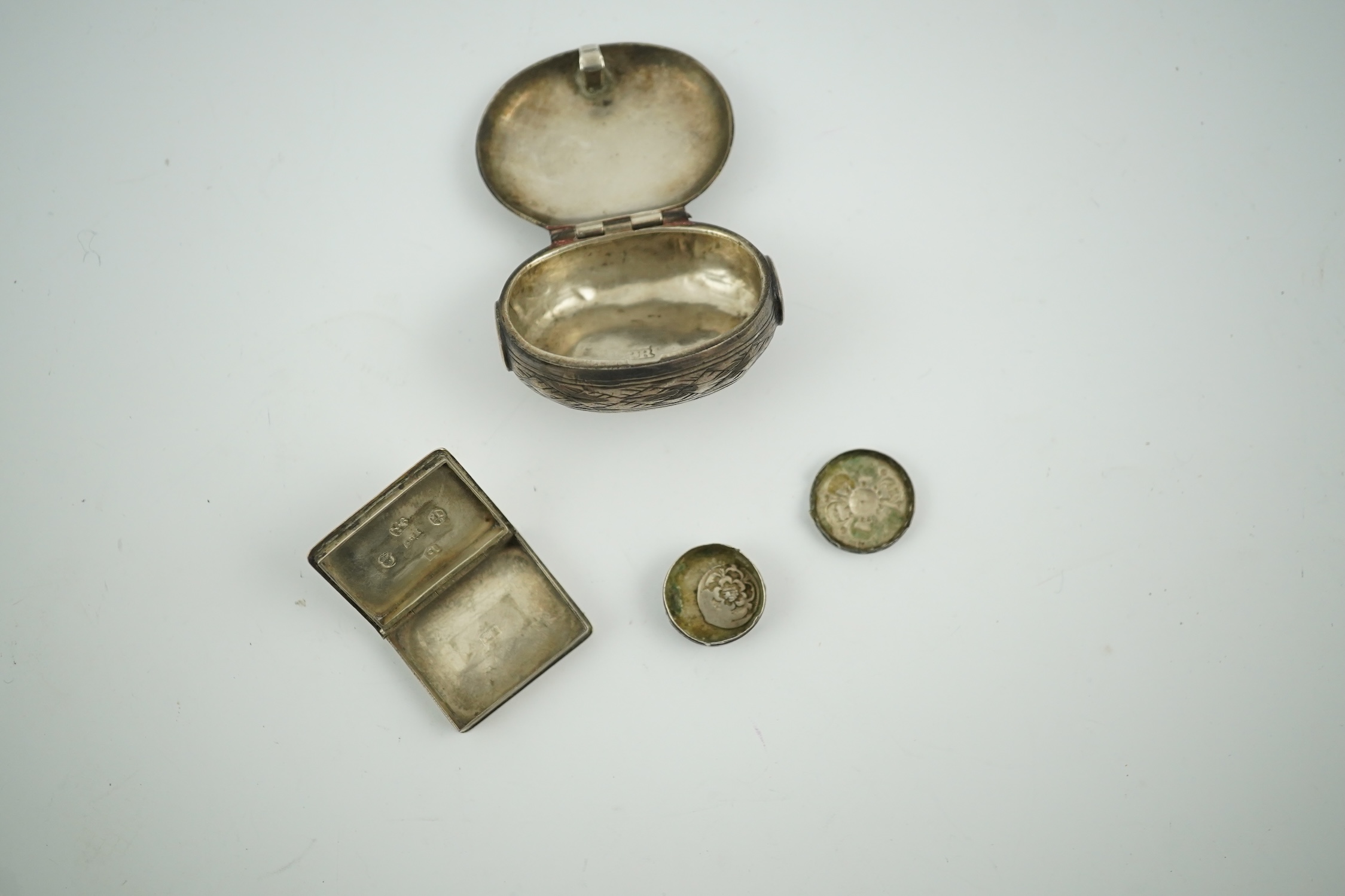 A 17th century style miniature silver snuff box, 40mm, a miniature 'book' box and a token/counter box with one counter. Condition - poor to fair